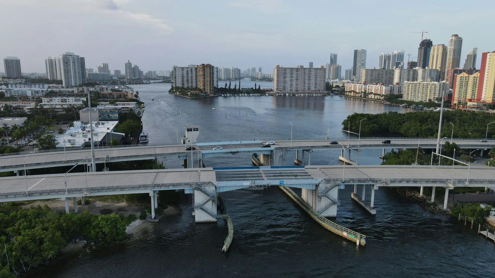 A boat on the Miami River, bridges and the towers of downtown beyond